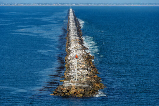 Breakwater seawall made of boulders built along Long Beach,California