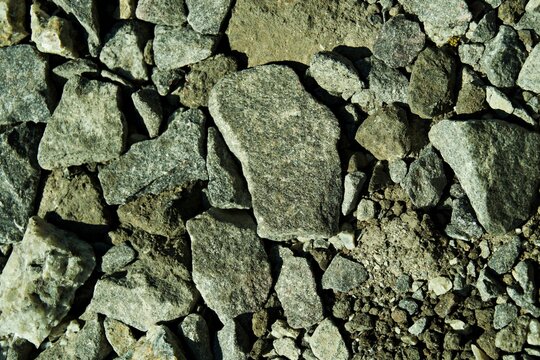Top view of coarse grey crushed granite stone texture background for construction and landscaping