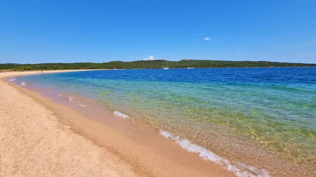 Beautiful turquoise sea and sandy beach on a sunny summer day, in Sardinia, Italy