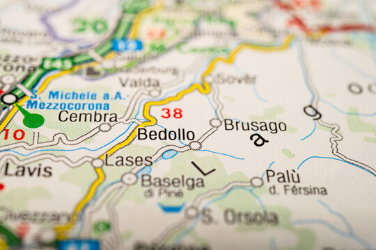 Macro view of printed map highlighting Bedollo and surrounding mountain villages in Trentino northern Italy.