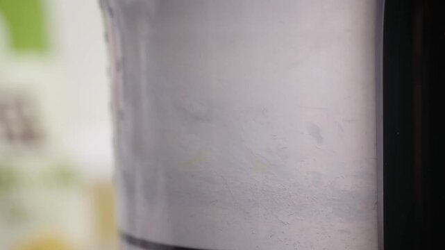 A detailed close-up shot showing white flour and powdery ingredients inside a transparent plastic or glass blender jar, illustrating the initial steps of baking a homemade dessert pie or pastry.