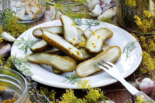 Traditional pickled cucumbers, pickled using the natural fermentation method, on a plate, close-up view