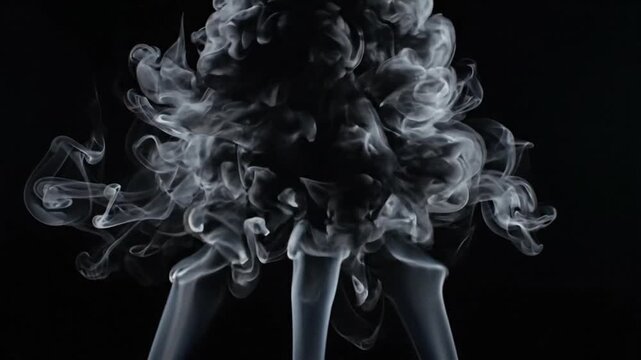 Abstract smoke patterns rising against a dark background with swirling shapes and textures