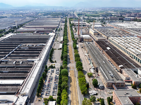 Torino, Piemonte, Italy - 24 June 2026: Aerial view of the Battery Technology Center STELLANTIS surrounded by large industrial factory buildings, parking lots, and tree-lined roads.