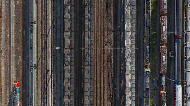 Portugal - 24 June 2026: Aerial view of a train terminal with multiple parallel tracks and various trains parked at the station.