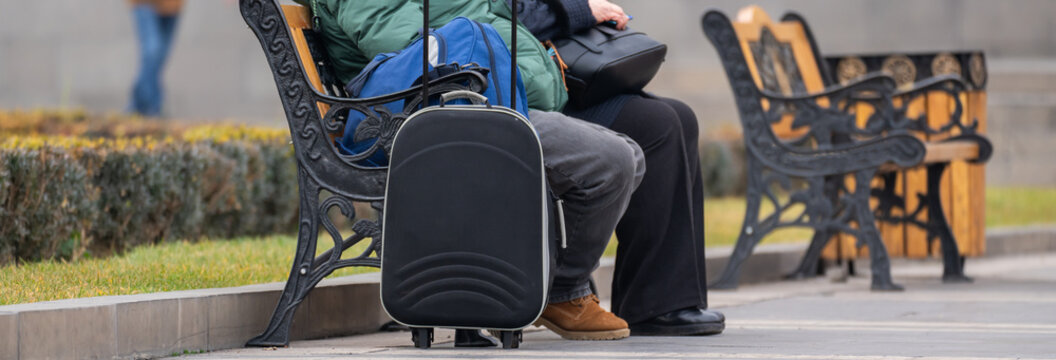 Travelers sitting in the city, admiring the scenic views, architecture, and vibrant atmosphere, enjoying sightseeing and capturing memorable urban experiences.
