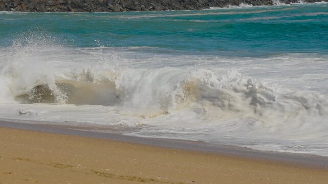 Big shorebreak barrel on the sand at wedge