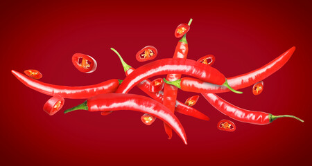 Naklejka premium Chili peppers in air against red background. Banner design