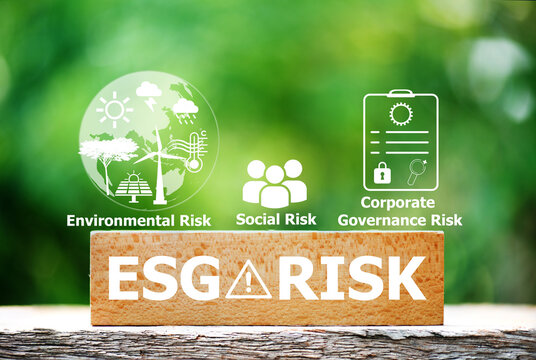 ESG Risk text on wood and icons on natural background.Sustainability risks arising from environmental, social, and governance factors concept.
