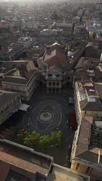 Aerial view of Teatro Massimo Bellini and the surrounding square with historic buildings, rooftops, and urban patterns in Catania, Sicily, Italy.