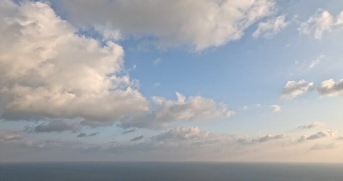 Clouds Ocean Sky moving white and gray clouds over a vast blue ocean horizon during daytime