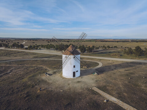 Aerial view of the historic Windmills Manchegos in the arid landscape of Mota del Cuervo, Castilla-La Mancha, Spain.