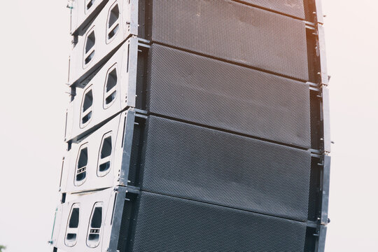 Stacked line array speakers creating high quality audio for a concert or live performance, projecting sound across a venue