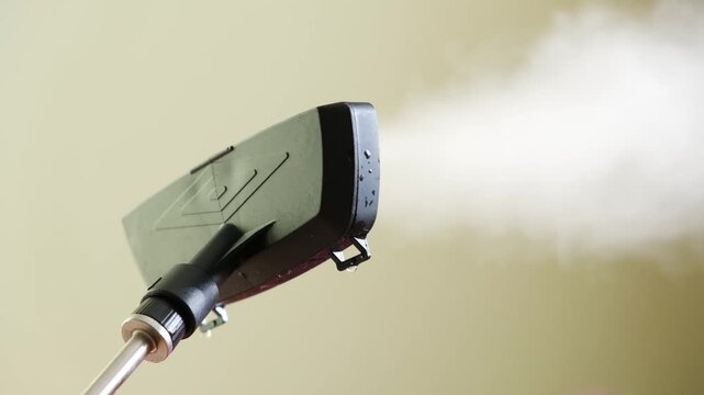 Cleaning with steam at home on a regular day in a simple indoor setting using a steam cleaner on various surfaces