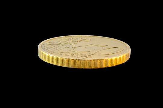 Side-angle view of a 50-cent Euro coin's reverse. Features the face value and European map on a golden-toned Nordic gold surface, isolated on a plain transparent black background.