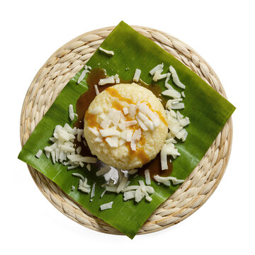 Filipino Kakanin Sweet Rice Cake An elegant plate of puto (steamed rice cake) topped with grated coconut and a drizzle