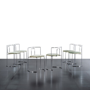 group of six chairs with chromed steel rod frame and padded seat covered in fabric.