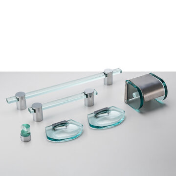 Bathroom accessory set, made of thick cut glass and chrome-plated metal. Includes towel rack, soap dish, and toilet paper holder.