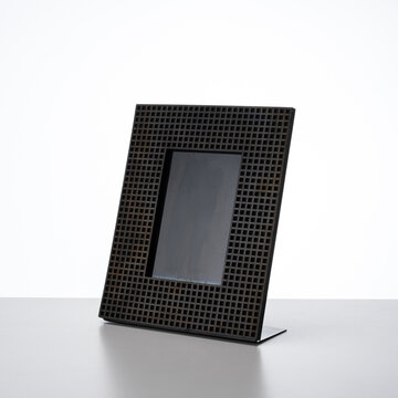 metal photo frame, features a modern design with an elegant perforated grid pattern.