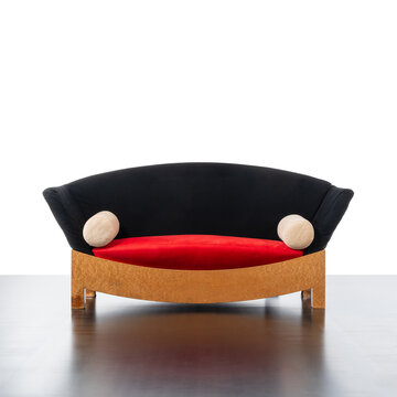 Front view of the sofa with maple burl frame, black fabric backrest and red seat.
