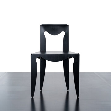 Front view of black designer chair, made of shaped and curved aluminum
