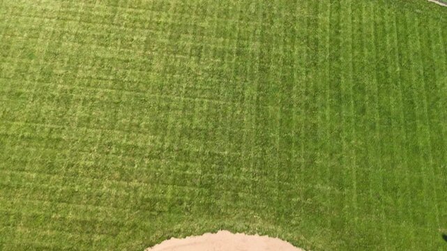 High aerial view of empty little league baseball diamond field in public community park on sunny summer day showcasing youth sports facilities