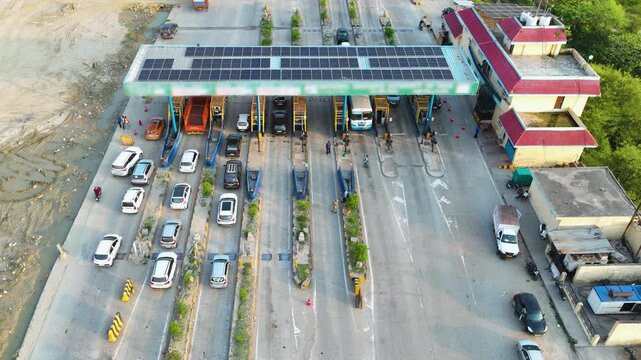 Drone Hyperlapse shot of cars passing through automated fastag toll plaza gates. Traffic passing through the cashless RFID payment gates.