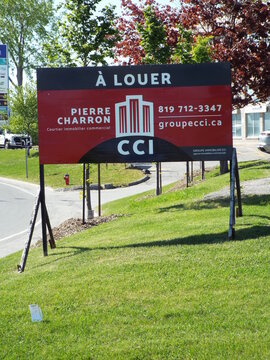 Gatineau,Quebec, Canada &ndash; May 17, 2026:A commercial real estate sign reads "&Agrave; LOUER" (for lease), featuring contact information for Pierre Charron, CCI on rue Jean Proulx.
