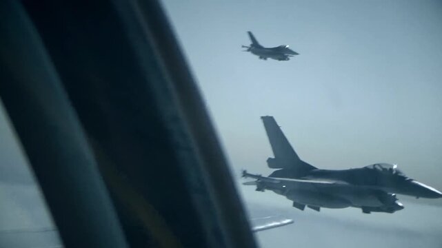 Fighter jet military aircraft maneuvering over the wing in 4K Ultra HD footage
