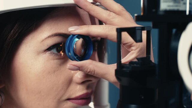 Female patient undergoing clinical eye examination with focus on iris and pupil. Concept ophthalmology, vision diagnostics and preventive healthcare.
