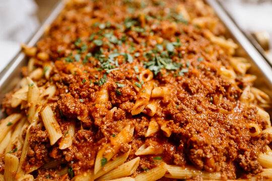 Freshly cooked penne pasta with traditional minced beef Bolognese sauce