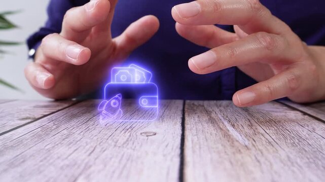 Financial growth and increased income. Close-up of a pair of hands on a table, protecting a virtual wallet icon with a rocket.
