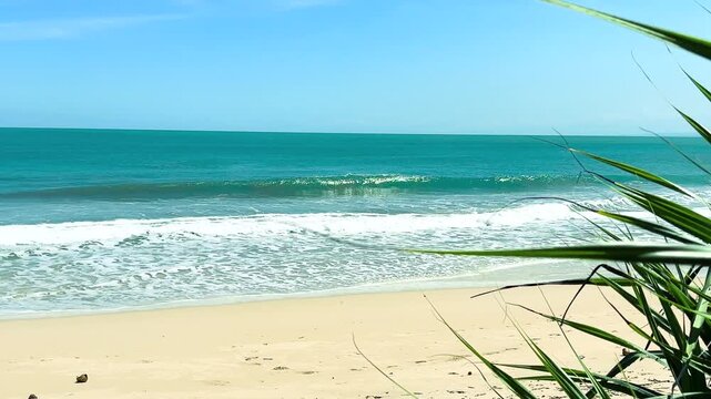 Garut, West Java - Indonesia: May 30, 2026 : A white-sand beach with clear weather and calm waves; a beautiful beach with fine white sand. Beach with a blue sky