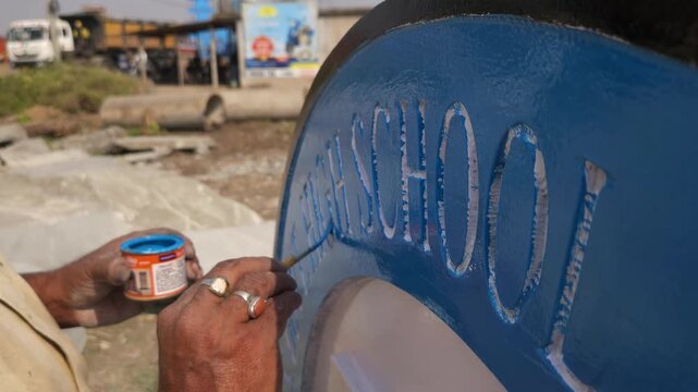 Indian Stone Sculpture Artist Hand Painting Platinum Jubilee School Logo Sculpture, Traditional Stone Craftsmanship, Artisan at Work, Odisha India
