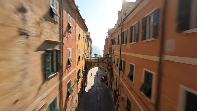 Aerial drone forced perspective view over narrow historic streets with bright colorful rooftops and architectural patterns in an old coastal town