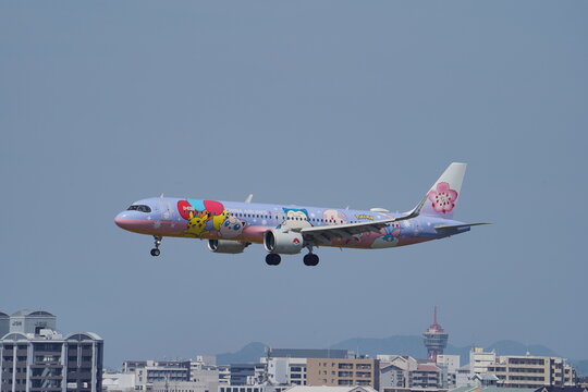 A China Airlines Airbus A321neo (B-18101) in Pikachu Jet Pokemon special livery on approach over the city to Fukuoka Airport on May 4, 2024 in Fukuoka, Japan.