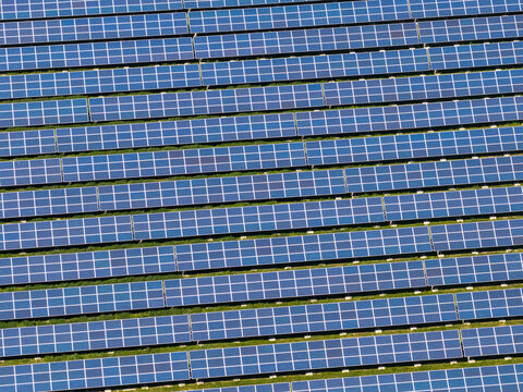 Aerial view of rows of solar panels in a large solar farm in Slavkov u Brna, South Moravian Region, Czechia.