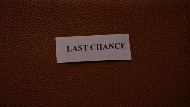 Last Chance Promotion Note on Brown Leather Texture Background