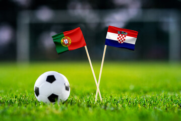Naklejka premium Portugal vs Croatia, national flags before international football tournament Round of 32 match, football on green grass with goal in the background, Toronto, Ontario, Canada, July 2, 2026