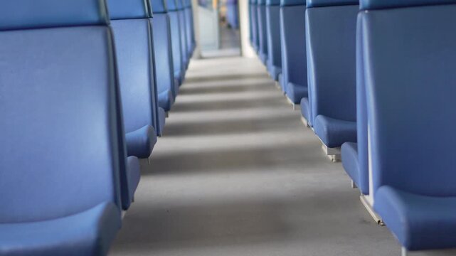 Train interior seats, empty rows inside a public transport vehicle providing a quiet atmosphere during commute in a modern train carriage
