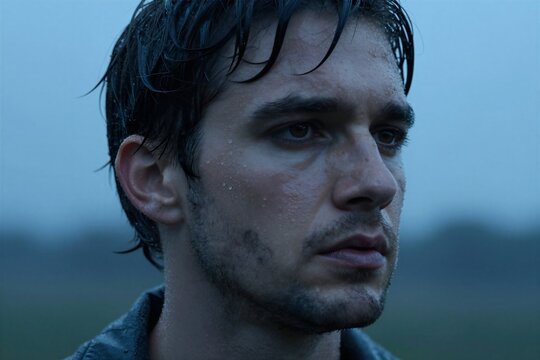Close Portrait Of Individual Contemplative Pensive Subject Dark Hair With Water Droplets Clinging To Suggesting Recent Exposure Rain