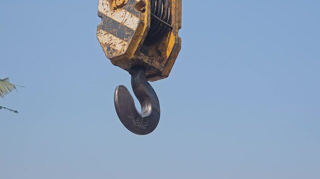 Mobile Crane Boom with Heavy Duty Lifting Hook Against Clear Blue Sky, Construction Equipment, Industrial Machinery, Engineering, Infrastructure, Crane Hook, 4K Cinematic Stock Footage