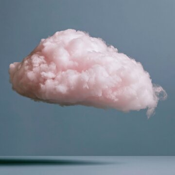 Fluffy pink cloud with a soft cottony texture floats against a muted blue background for weather forecast design and creative compositing