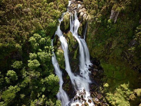 Aerial view of Waipunga Falls cascading over mossy rocks surrounded by dense native forest in Waipunga, Hawke's Bay Region, New Zealand.