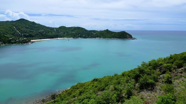 Aerial drone footage of Thong Nai Pan Beach on the northeast coast of Koh Phangan, Surat Thani, Thailand. The video showcases white sandy beach, turquoise water, tropical coastline, and surrounding gr