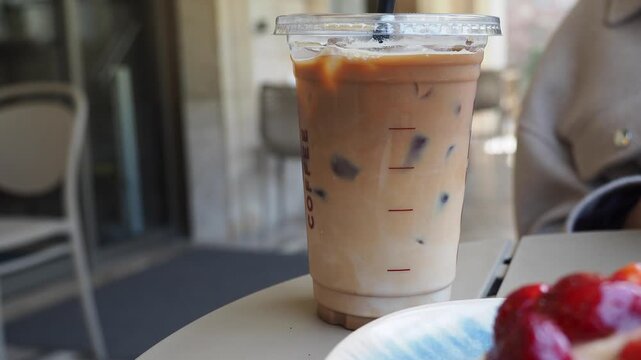 Enjoying iced coffee at a cafe in the afternoon