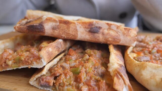 Turkish Pide on a wooden tray on a table