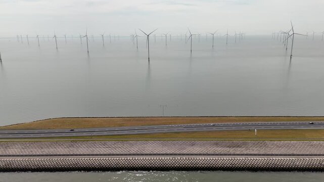 Offshore wind farm generating renewable energy next to highway