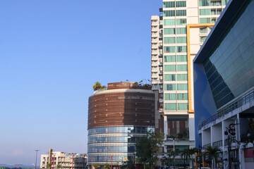 Modern High Rise Buildings and Cylindrical Architecture Against Blue Sky © Jumain