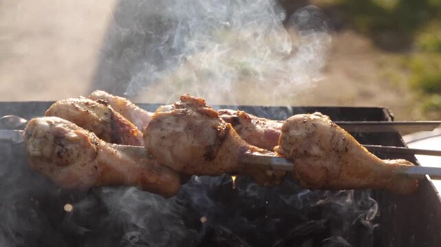 chicken meat is being grilled on the barbecue